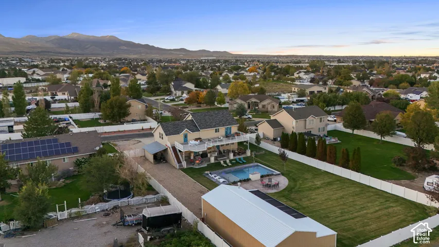 Residence featuring a two-story design, attached two-tier deck, and an in-ground swimming pool