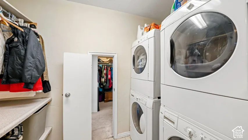 Laundry area featuring two stackable washer and dryer units