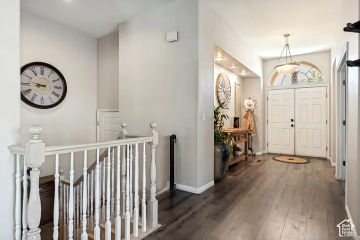 Wood-finish flooring extending from the entry to the staircase