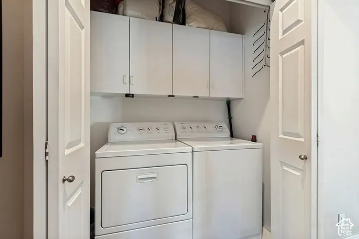 Built-in white cabinetry, paneled doors, and white walls