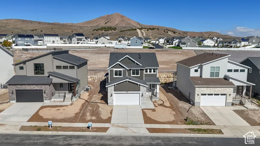 Modern architectural style with a two-car garage, and a light gray exterior