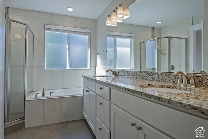 Dual vanity with granite countertops, undermount sinks, and brushed nickel fixtures
