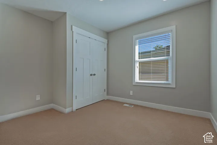 Neutral-toned walls complement carpeted flooring