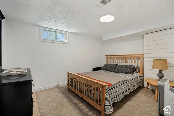 Carpeted flooring, white walls, and a built-in window