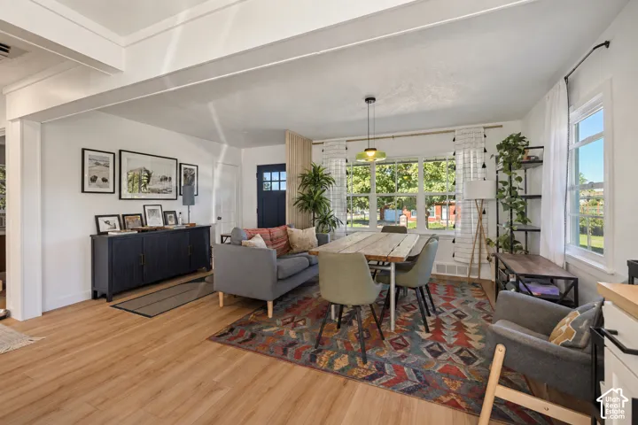 Wood-finish flooring throughout, white trim, and numerous windows provide abundant natural light