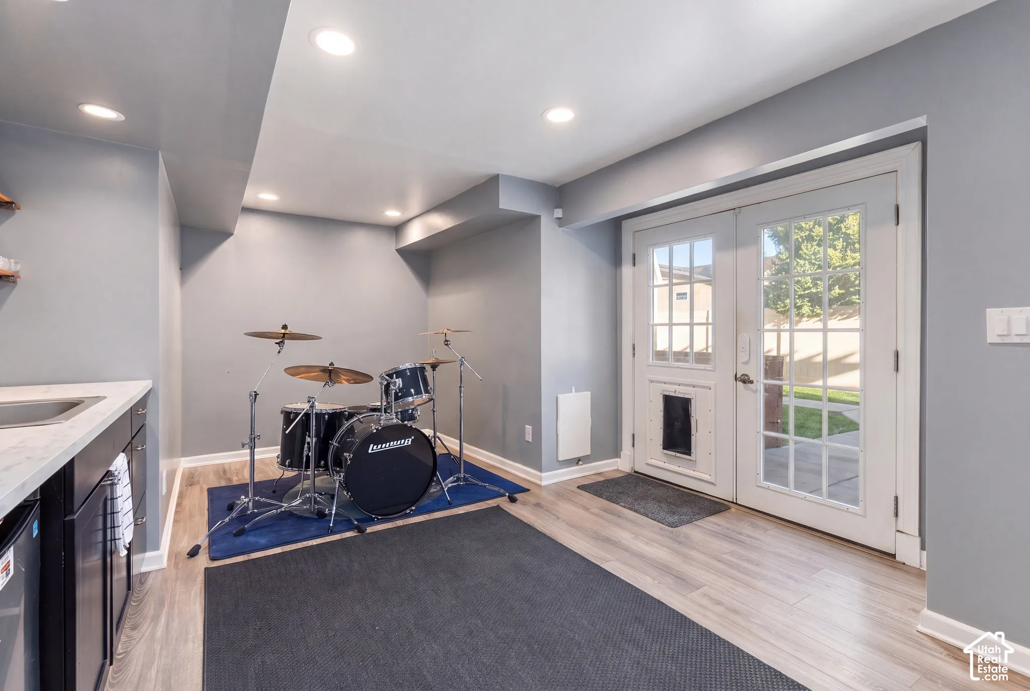 Recessed lighting illuminates the space featuring wood-finish flooring
