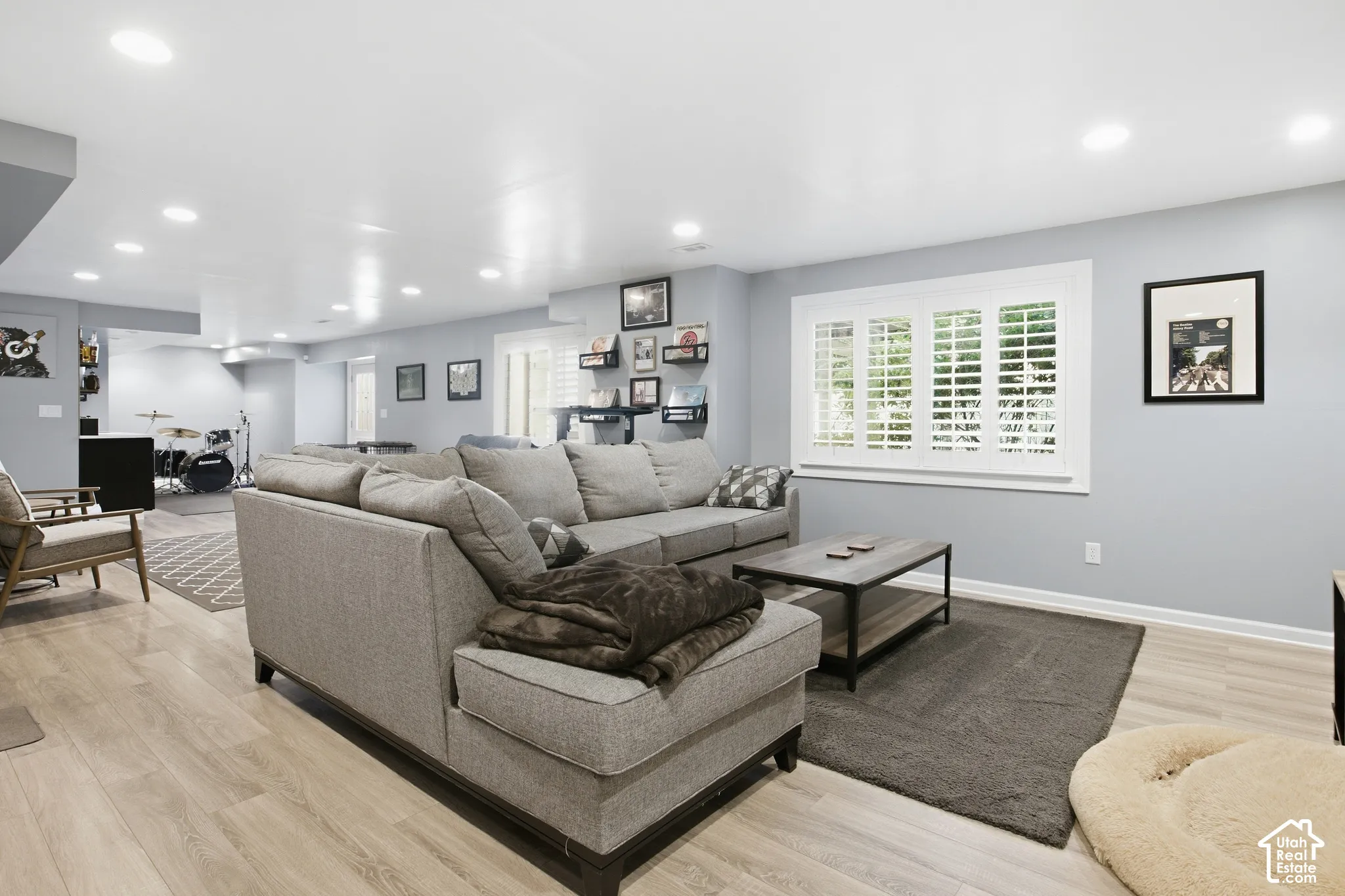 Recessed lighting, wood-finish flooring, plantation shutters, and a neutral wall color