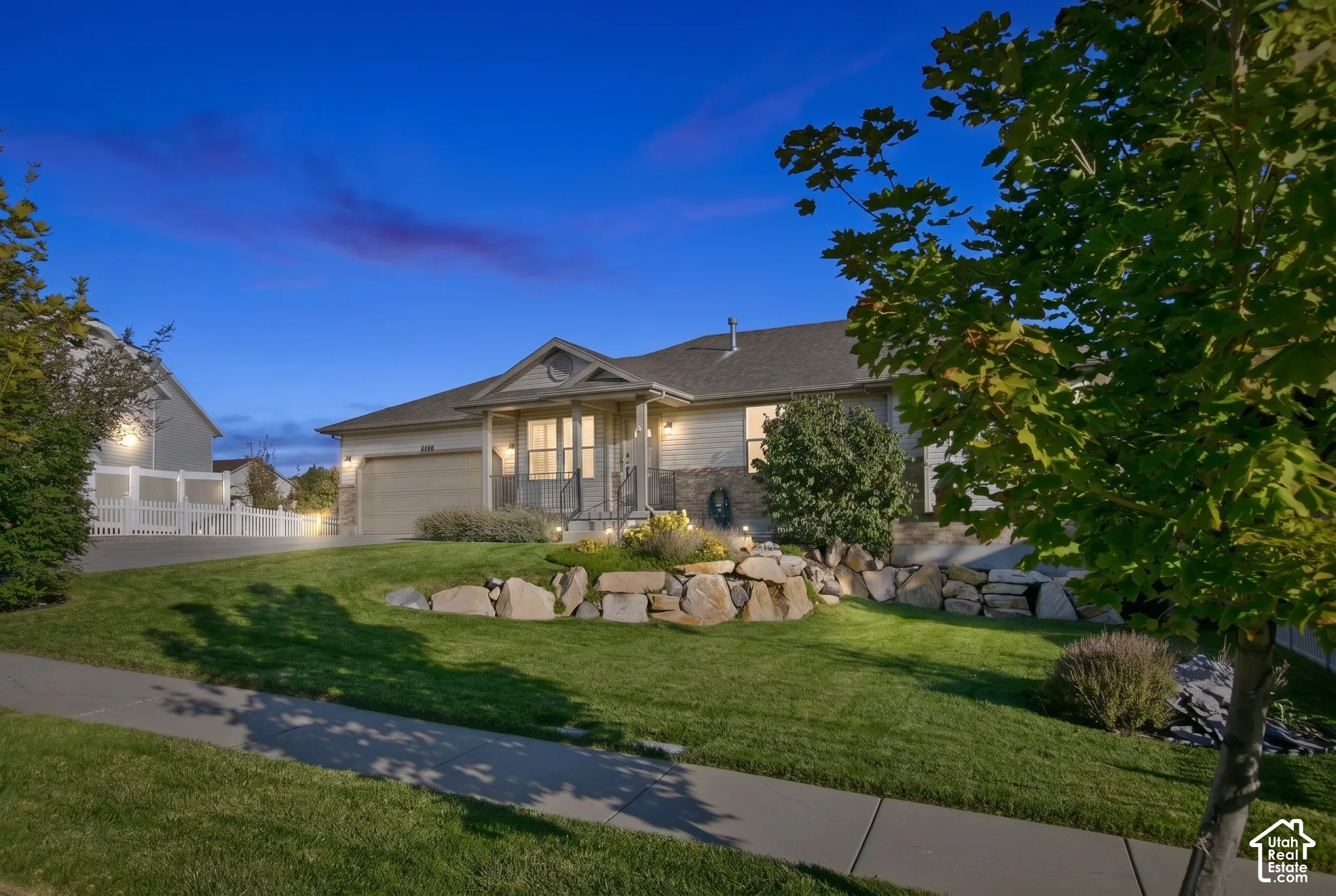 Manicured lawn with a stone retaining wall and mature landscaping