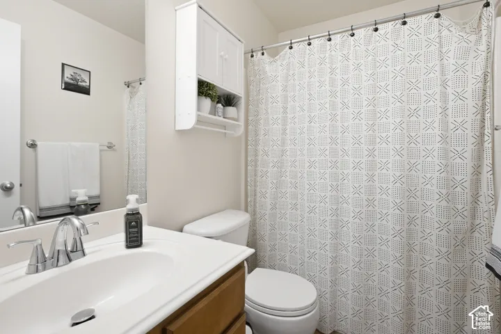 Wood-finish vanity with an integrated sink and chrome faucet