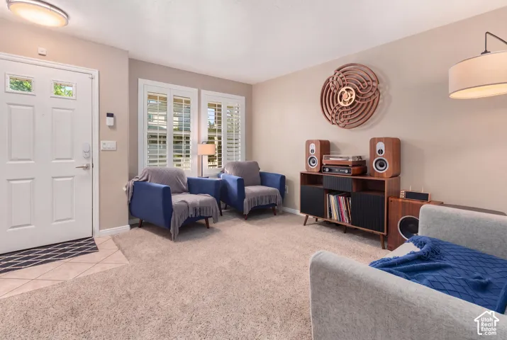 Entryway with tile flooring transitioning to carpet