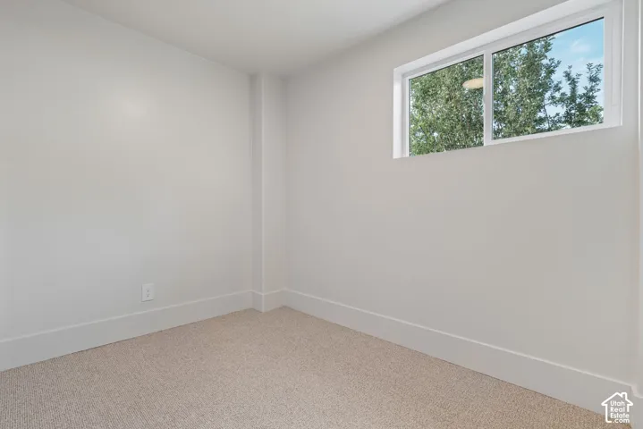 Light-colored carpeting with white walls and trim