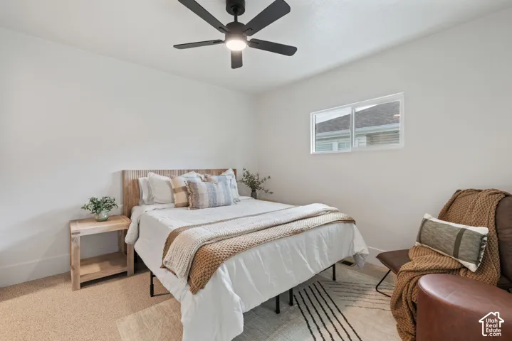 Recessed lighting, a ceiling fan, a window, and carpet flooring