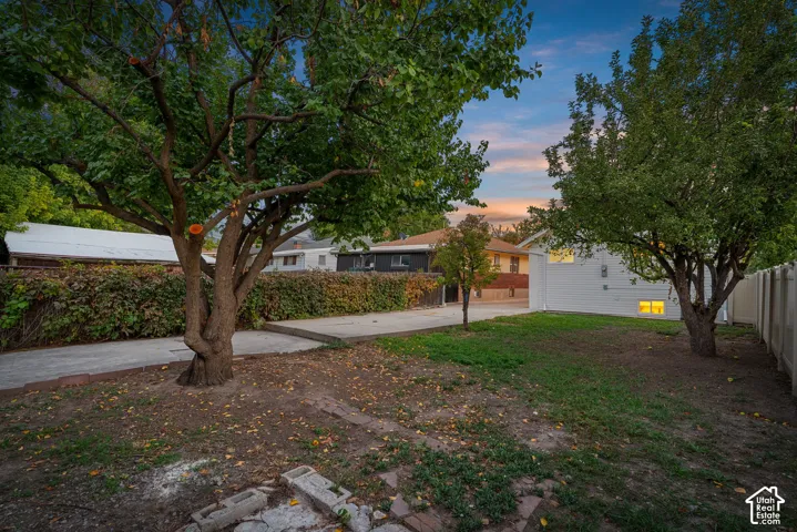 Expansive grass lawn featuring mature trees