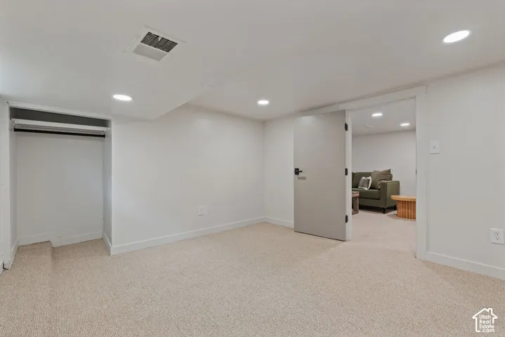 Recessed lighting, carpet flooring, and a built-in closet