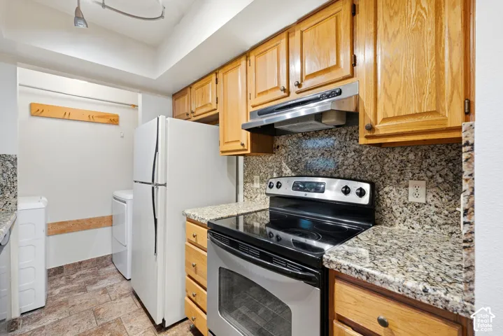 Wood-finish cabinetry paired with granite-finish countertops and backsplash