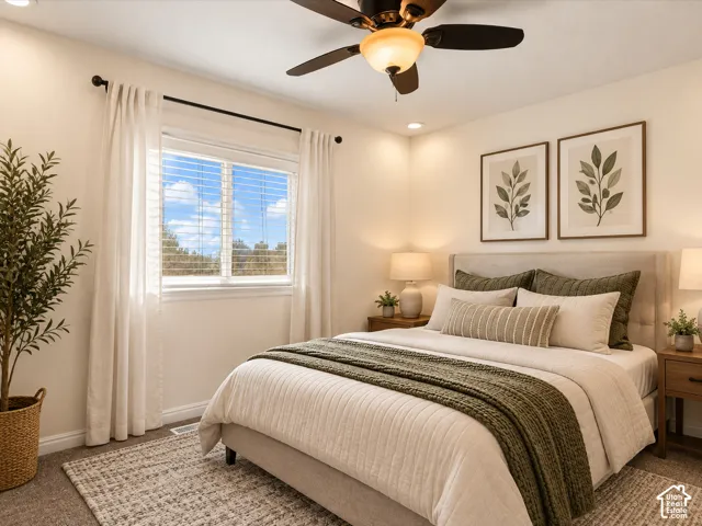 Window with blinds, ceiling fan with integrated lighting, recessed lighting, upholstered headboard, wood-finish nightstands. Virtually Staged