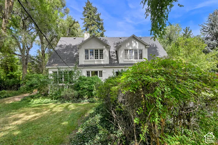 Gabled dormer windows and a shingled roofline