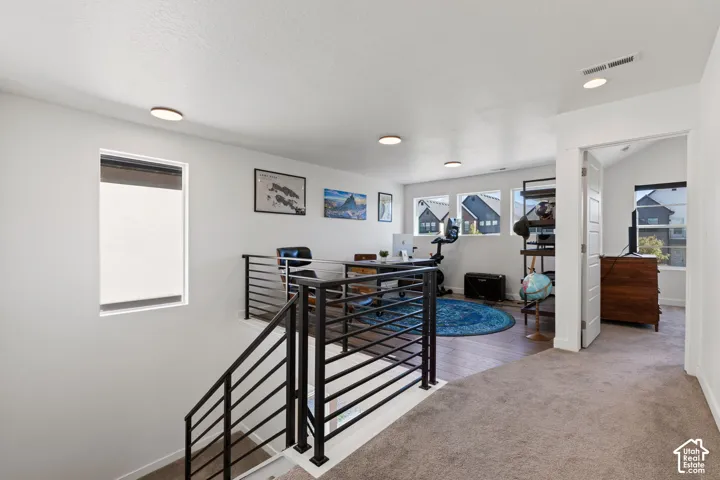 Open-concept upper level with an open railing staircase