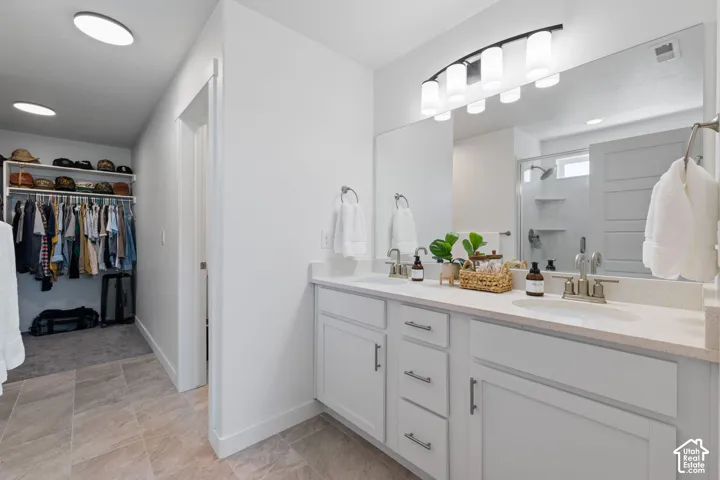 Dual vanity with white cabinetry and integrated sinks