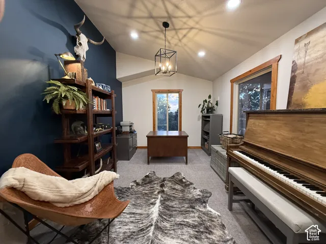 Vaulted ceiling with recessed lighting, exposed wood-frame windows, and plush carpeting