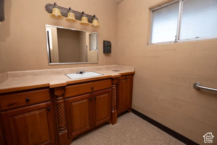 Wood-finish vanity with an integrated sink and light-toned countertop