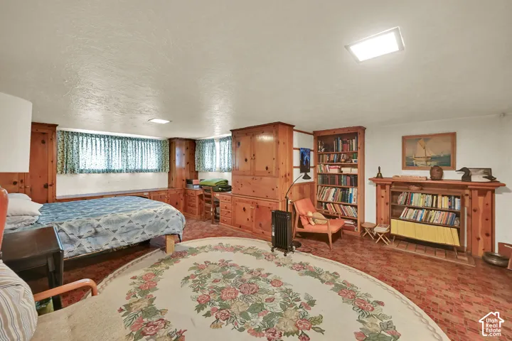 Wood-paneled walls with built-in storage, a built-in desk area, and a built-in bookshelf