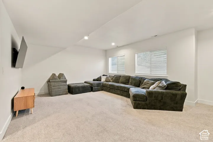 Recessed lighting illuminates the carpeted floor