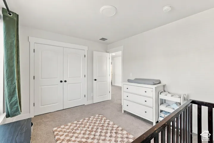 Carpeted flooring, white walls, white trim, and white doors