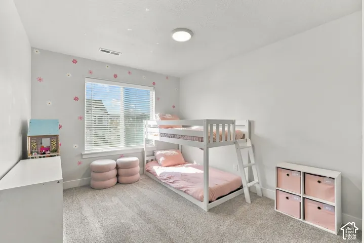 Carpeted flooring, single window with blinds, and flush-mount ceiling light