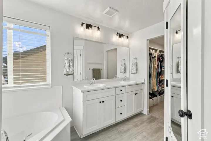 Dual vanity with white cabinetry, light countertops, and individual sinks