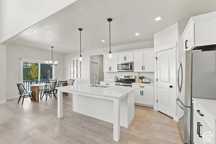 Open-concept living space with light wood-finish flooring