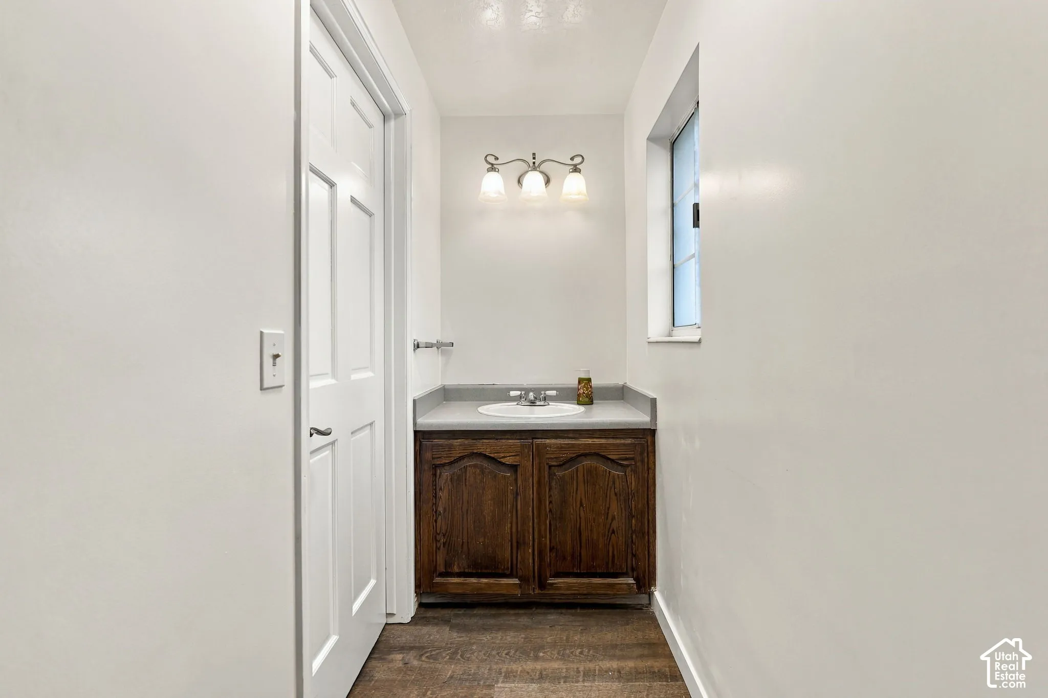 Wood-finish flooring with a white paneled door