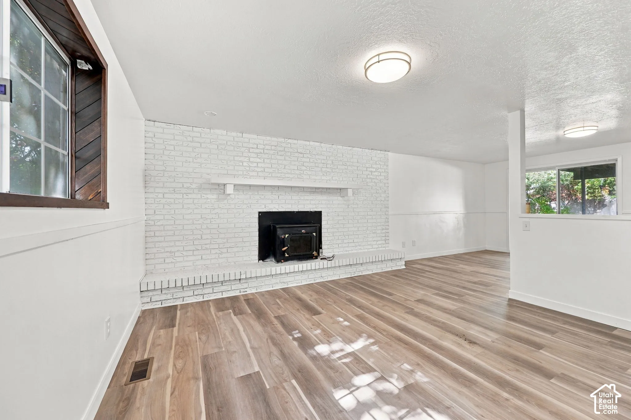 White painted brick fireplace with a wood mantel