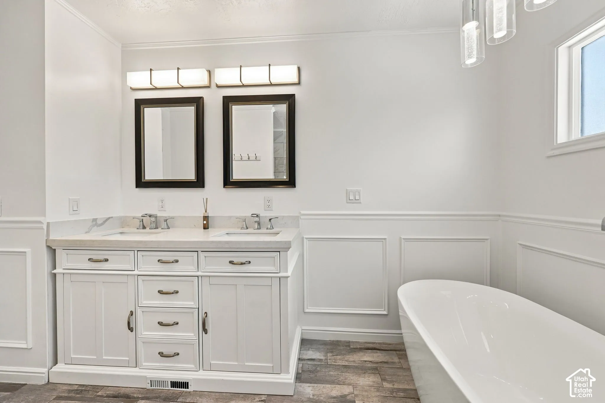White double vanity with integrated sinks, brushed nickel faucets, and stone countertop