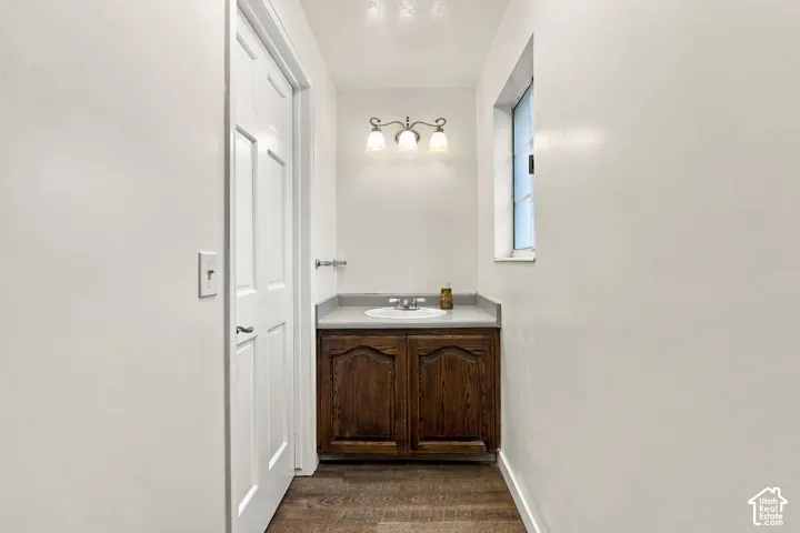 Wood-finish flooring with a white paneled door