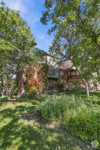 Brick exterior with a glass block window feature, and mature trees providing natural shade