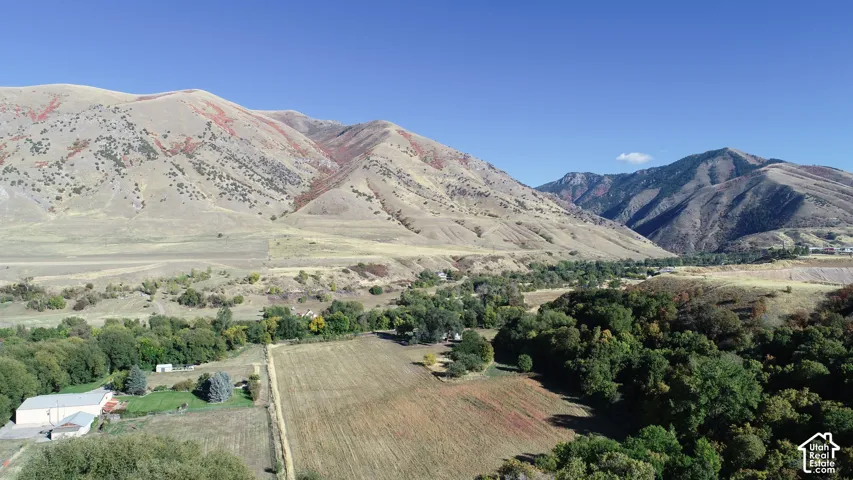 Expansive land with distant mountainous terrain, surrounded by a natural landscape