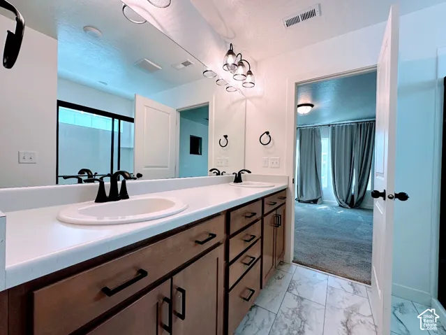 Dual vanity with a white countertop and integrated sinks