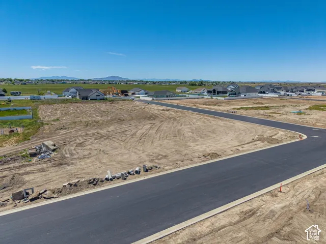 Expansive undeveloped lot with paved road frontage and curbed perimeter