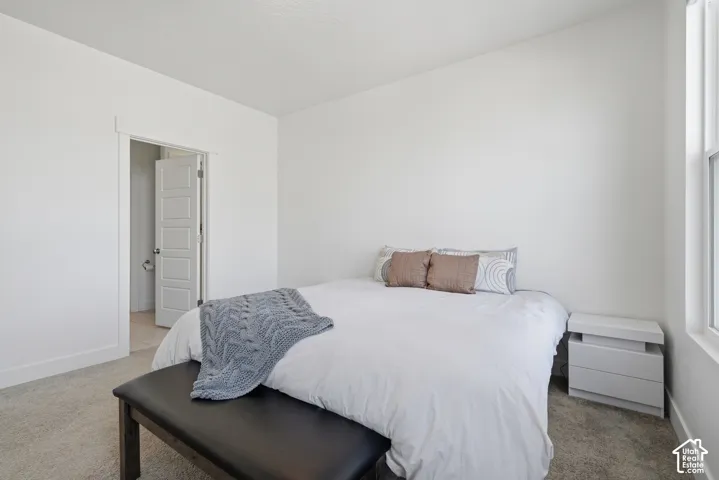 Neutral color palette, carpeted flooring, window, white paneled door, and recessed lighting