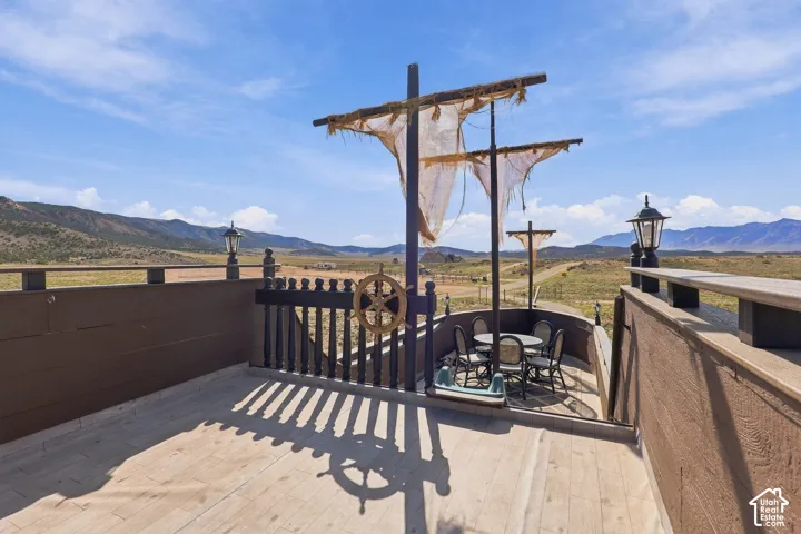 Terrace with decorative mast features and a ship's wheel