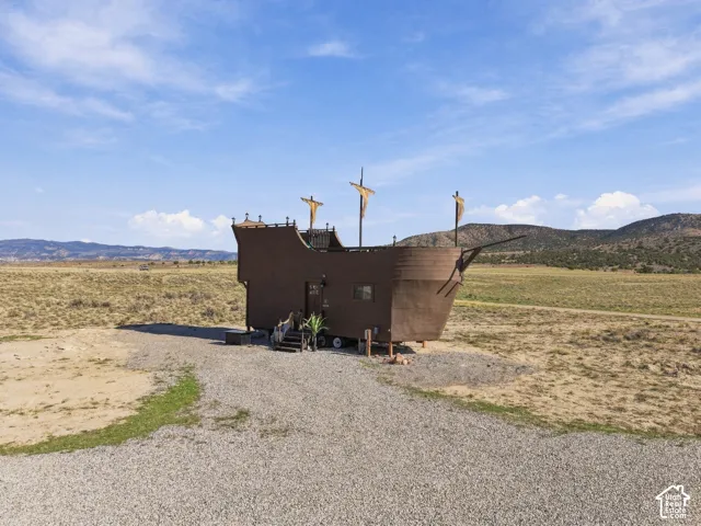 Unique ship-shaped exterior structure with decorative masts and flags