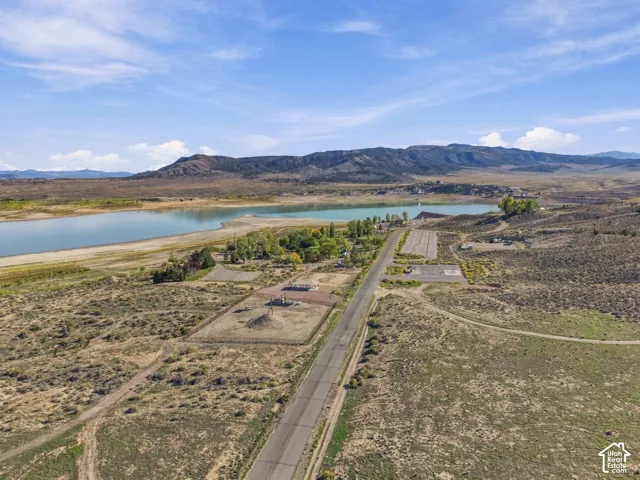 Expansive waterfront property featuring a paved road, multiple clearings, and undeveloped land
