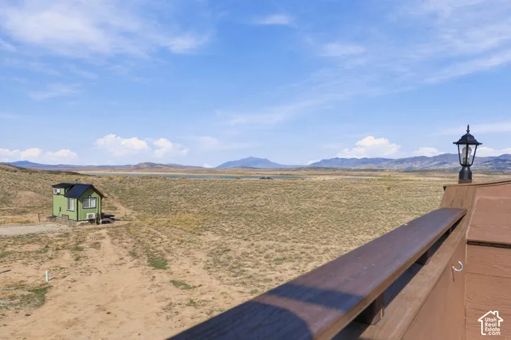 Expansive open terrain with distant mountains and a body of water