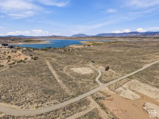 Expansive undeveloped land with a distant lake and mountain backdrop