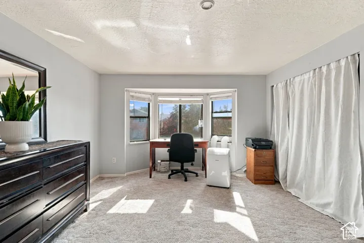 Bay window with multiple panels, recessed ceiling lighting, light gray wall paint, and textured ceiling
