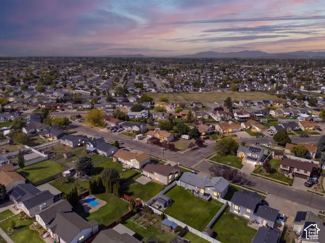 Residential neighborhood with diverse home styles, paved streets, and mature landscaping