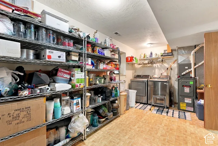 Utility area featuring a natural gas furnace and water heater
