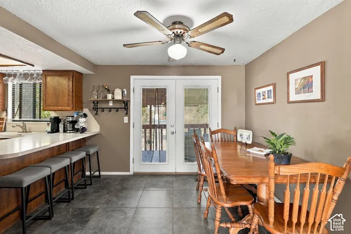 Kitchen featuring wood cabinetry, white countertops, built-in breakfast bar, and wood-finish flooring