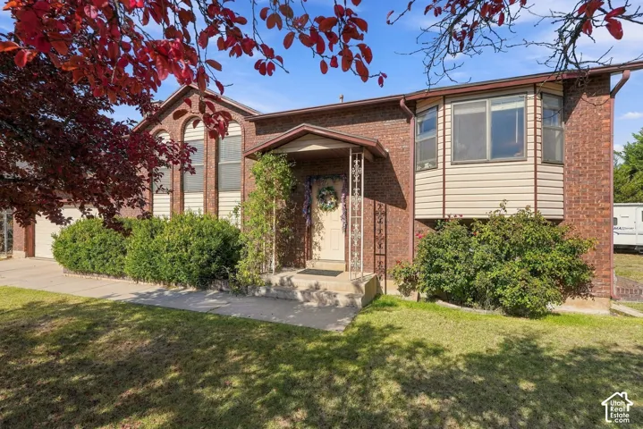 Brick facade, arched windows, covered entry, bay window, established landscaping